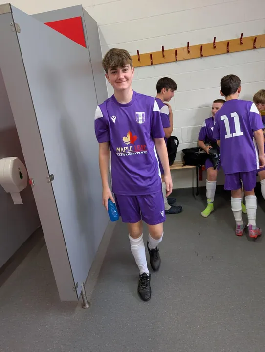 A young player in the purple Maple Leaf Automotive kit